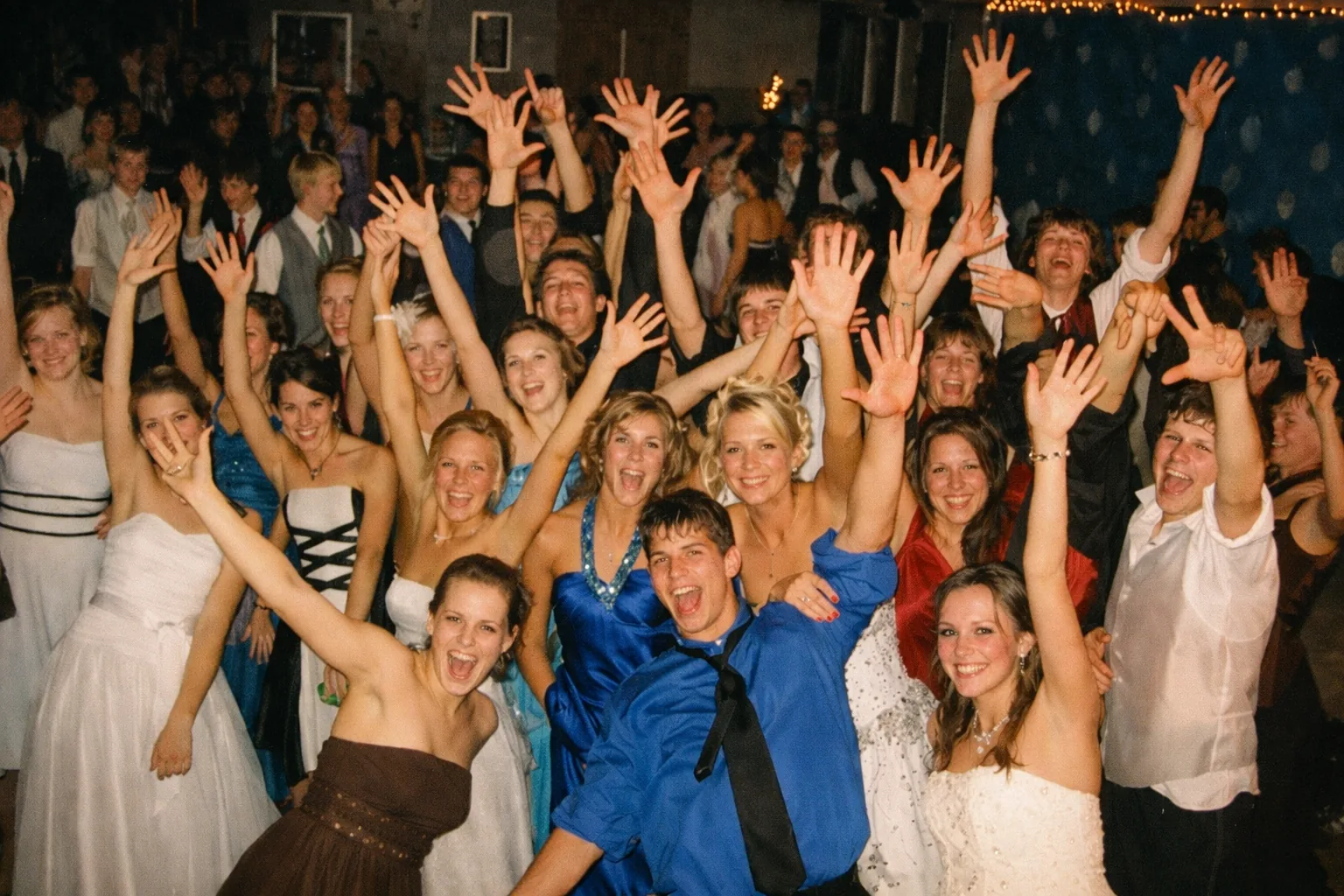 Kids having fun at a school dance with colorful lighting